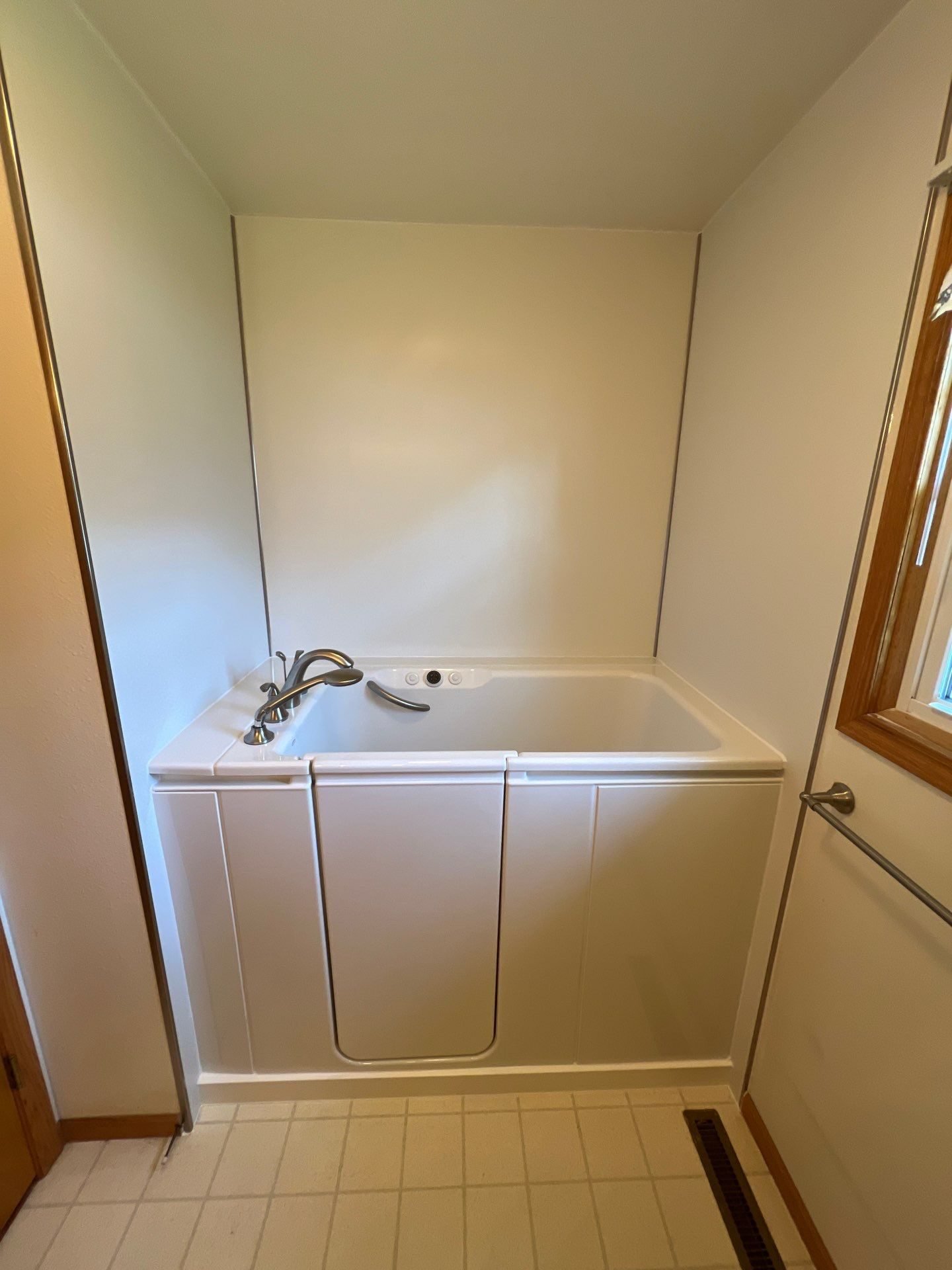 Walk-in tub conversion with gray tile surround