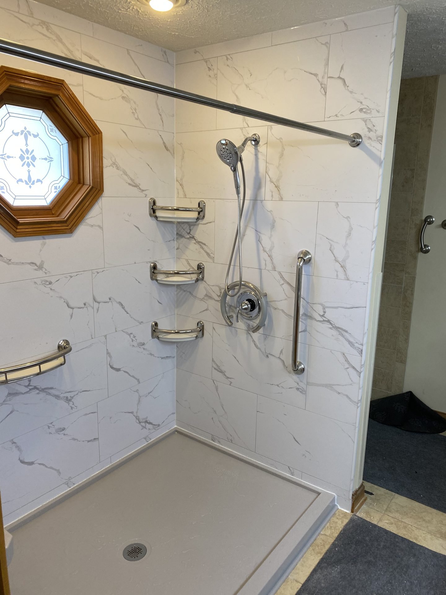 Marble-look corner shower with ADA grab bar