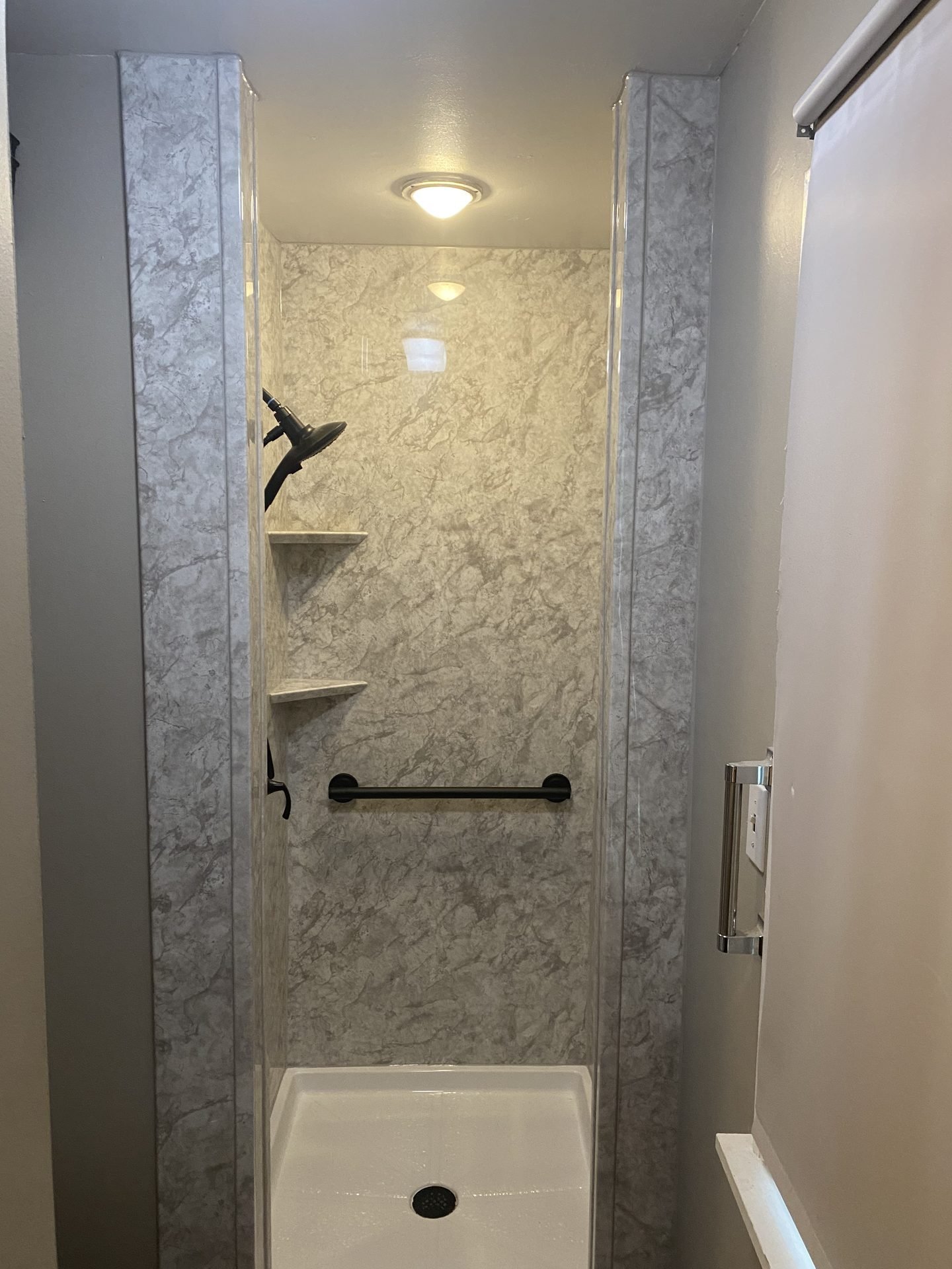 Gray and white walk-in shower stall
