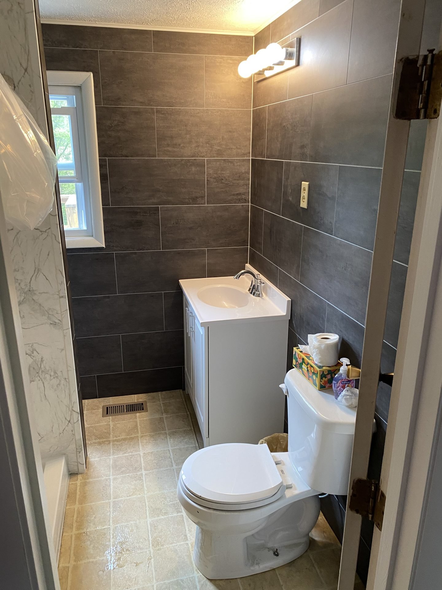 Charcoal tile bathroom with vanity and walk-in shower