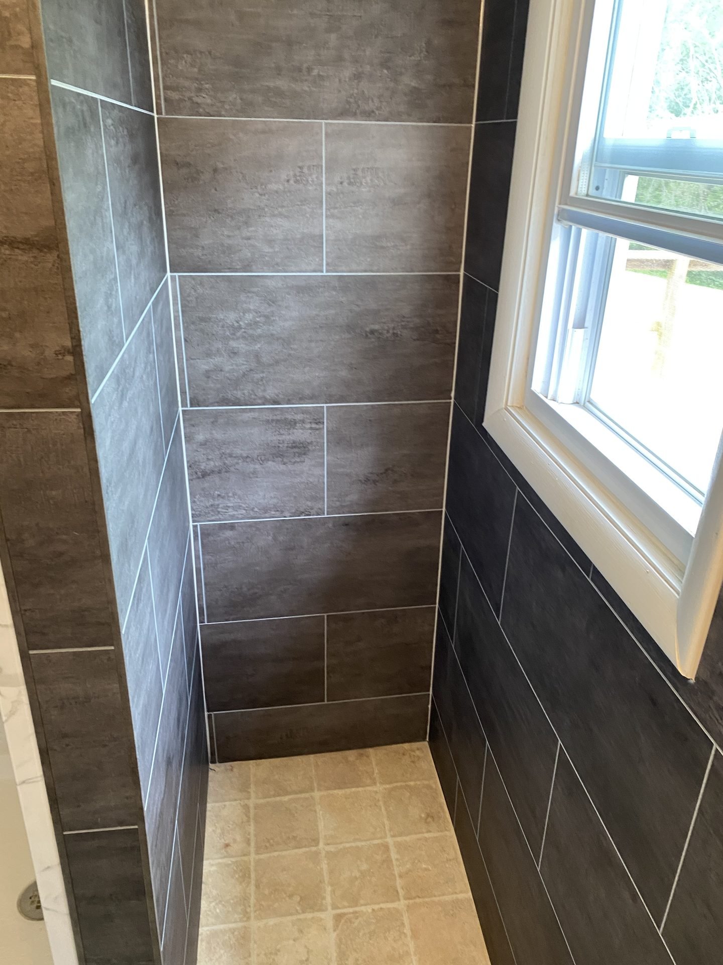 Textured stone-look shower with natural light
